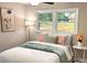 Cozy bedroom featuring a comfortable bed, soft pillows, and bright natural light from the double windows at 4296 Langdon Dr, Decatur, GA 30035
