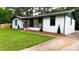 Beautifully renovated home with a modern exterior, fresh paint, and a welcoming front porch at 4296 Langdon Dr, Decatur, GA 30035