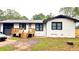Exterior view of the home, featuring a deck, fresh paint, dark trim, and updated garage door at 4296 Langdon Dr, Decatur, GA 30035