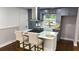 Modern kitchen island with stainless steel appliances, marble countertops, and elegant seating at 4296 Langdon Dr, Decatur, GA 30035