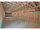 Large unfinished basement with exposed rafters, concrete floors and studded walls ready for customization at 85 Presley Farm Pkwy, Rockmart, GA 30153