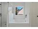 Bright bathroom featuring a soaking tub, separate glass shower, and white subway tile surround at 85 Presley Farm Pkwy, Rockmart, GA 30153