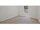 This bedroom is bright, featuring neutral carpet and a window view at 85 Presley Farm Pkwy, Rockmart, GA 30153