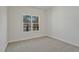 Bedroom features a neutral carpet, white walls, and a window overlooking the yard at 85 Presley Farm Pkwy, Rockmart, GA 30153
