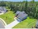 Beautiful single-Gathering home with an attached two-car garage and a large, lush front lawn at 85 Presley Farm Pkwy, Rockmart, GA 30153