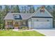 Charming, light blue, one-story home with a welcoming front porch and an attached two-car garage at 85 Presley Farm Pkwy, Rockmart, GA 30153