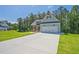 Light blue one-story home with a two-car garage and a long concrete driveway on a sunny day at 85 Presley Farm Pkwy, Rockmart, GA 30153