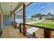 Cozy covered front porch featuring wood flooring, rustic railing, and stylish pendant lighting at 85 Presley Farm Pkwy, Rockmart, GA 30153