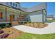 Inviting one-story home with light blue siding, a covered porch, and professionally landscaped front yard at 85 Presley Farm Pkwy, Rockmart, GA 30153
