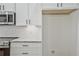 Modern kitchen featuring stainless steel microwave, white cabinets and granite countertop at 85 Presley Farm Pkwy, Rockmart, GA 30153