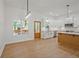 Modern kitchen boasts white cabinets, stainless appliances, island, and wood floors, naturally lit from the large window at 85 Presley Farm Pkwy, Rockmart, GA 30153