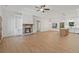 Open-concept living area with hardwood floors, fireplace, and built-in shelving flowing into the kitchen at 85 Presley Farm Pkwy, Rockmart, GA 30153