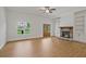 Spacious living area with hardwood flooring, stone fireplace, and large windows for natural light at 85 Presley Farm Pkwy, Rockmart, GA 30153