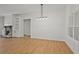 Living room features clean lines, board and batten detail, wood floors, modern lighting, and cozy fireplace at 85 Presley Farm Pkwy, Rockmart, GA 30153