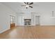 Open living space with hardwood floors, a cozy fireplace, and views of the entryway at 85 Presley Farm Pkwy, Rockmart, GA 30153