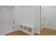 Well-organized mudroom featuring a built-in bench with storage cubbies and adjacent laundry room at 85 Presley Farm Pkwy, Rockmart, GA 30153