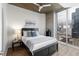 Cozy bedroom with large windows, city views, and hardwood floors at 855 Peachtree Ne St # 1508, Atlanta, GA 30308