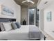 Bright bedroom with a queen-sized bed and concrete accent wall, cityscape view, and modern decor at 855 Peachtree Ne St # 1508, Atlanta, GA 30308