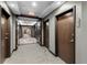 Modern hallway with carpet and dark wooden doors at 855 Peachtree Ne St # 1508, Atlanta, GA 30308