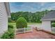 Backyard featuring a brick patio, white picket fence, and lush greenery, perfect for outdoor relaxation and entertainment at 2759 Bay Ridge Dr, Loganville, GA 30052
