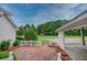 Backyard featuring a brick patio, white picket fence, and lush greenery, perfect for outdoor relaxation and entertainment at 2759 Bay Ridge Dr, Loganville, GA 30052