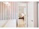 Bathroom leading into the bedroom, featuring a vanity, bright lighting, and colorful wallpaper at 2759 Bay Ridge Dr, Loganville, GA 30052