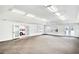 Large bonus room with neutral carpet, bright lighting, and doors leading to the outside at 2759 Bay Ridge Dr, Loganville, GA 30052