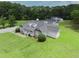 Aerial view shows charming home with stone accents, dormer windows and well-maintained lawn at 2759 Bay Ridge Dr, Loganville, GA 30052