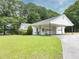 Charming home featuring a covered parking area and lush green lawn at 2759 Bay Ridge Dr, Loganville, GA 30052