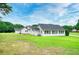 Well-maintained home with lush green lawn, showcasing the property's curb appeal and serene surroundings at 2759 Bay Ridge Dr, Loganville, GA 30052