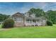 Beautiful home with stone accents, a covered front porch, and lush green lawn at 2759 Bay Ridge Dr, Loganville, GA 30052
