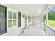 Covered porch featuring a swing, white railings, and views of the front yard at 2759 Bay Ridge Dr, Loganville, GA 30052