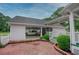 Spacious garage with an open carport, a brick driveway, and well-manicured landscaping, adding to the home's appeal at 2759 Bay Ridge Dr, Loganville, GA 30052