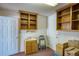 Functional laundry room with a sink, cabinets, and ample storage space at 2759 Bay Ridge Dr, Loganville, GA 30052