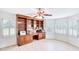 Home office with a built-in bookshelf, desk, wood floors, and white plantation shutters at 2759 Bay Ridge Dr, Loganville, GA 30052