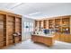 Well-lit home office featuring custom wooden bookshelves, a large desk, and ample storage at 2759 Bay Ridge Dr, Loganville, GA 30052