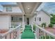 Inviting porch with a covered walkway and white railings, leading to the front door of this well-maintained home at 2759 Bay Ridge Dr, Loganville, GA 30052
