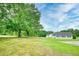 Lush lawn on property with mature trees, offering privacy and a park-like setting at 2759 Bay Ridge Dr, Loganville, GA 30052