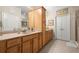 Bright bathroom with double vanity, wood cabinets, tile floor, and a glass-enclosed shower for a spa-like experience at 2797 Middlecreek Way, Cumming, GA 30041