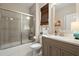 Bathroom featuring a shower-tub combo, granite vanity, and a decorative mirror at 2797 Middlecreek Way, Cumming, GA 30041