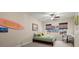 Cozy bedroom with a twin bed, natural light from a window, and unique wall decor for a personalized space at 2797 Middlecreek Way, Cumming, GA 30041