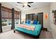 Bedroom with a black wood platform bed with colorful bedding and large windows with privacy shades at 2797 Middlecreek Way, Cumming, GA 30041