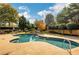 A large pool with stone decking surrounded by mature landscaping at 2797 Middlecreek Way, Cumming, GA 30041
