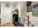 Carpeted staircase with hardwood floors and decorative art hanging on the wall at 2797 Middlecreek Way, Cumming, GA 30041