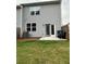 Backyard featuring gray siding, a small patio, and a well-maintained lawn at 3558 Eagle Court, Fulton, GA 30331