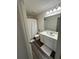 Clean bathroom with updated vanity, large mirror, and shower with curtain at 3558 Eagle Court, Fulton, GA 30331