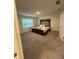 Spacious bedroom with soft carpet, large window, and a decorative padded headboard at 3558 Eagle Court, Fulton, GA 30331