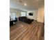 Bright and open living space featuring wood floors, a cozy sectional sofa, and modern decor at 3558 Eagle Court, Fulton, GA 30331