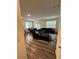 Bright open living area with wood floors, featuring a comfortable sectional sofa and dining space at 3558 Eagle Court, Fulton, GA 30331