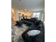 Open-concept living space with modern furnishings, a large sectional, and a view of the kitchen at 3558 Eagle Court, Fulton, GA 30331
